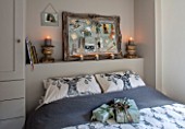MERRYWOOD, JACKY HOBBS HOUSE, LONDON: GUEST BEDROOM IN GREY AND WHITE. PRINTED STAG PILLOWS, SILVER PIN BOARD, CANDLES