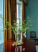 MARBURY HALL, SHROPSHIRE: DESIGNER SOFIE PATON-SMITH, BLUE DINING ROOM, VASE ON TABLE WITH BLOSSOM AND EASTER EGGS