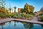 TAROUDANT, MOROCCO: DESIGNERS ARNAUD MAURIERES AND ERIC OSSART: PRIVATE GARDEN - SWIMMING POOL, TERRACE, CACTUS, APRIL, AFRICA, ALOE VERA, REFLCTIONS