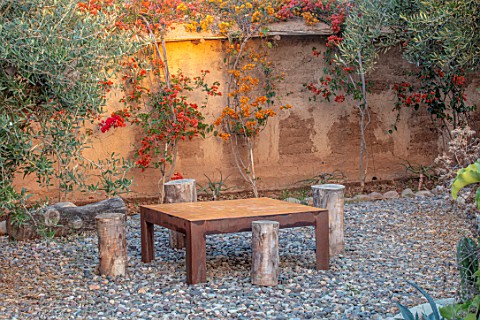 TAROUDANT_MOROCCO_DESIGNERS_ARNAUD_MAURIERES_AND_ERIC_OSSART_WOODEN_TABLE_AND_CHAIRS_MUD_WALL_BOUGAI
