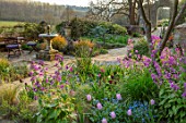GRAVETYE MANOR SUSSEX: SPRING, APRIL, COUNTRY, GARDEN, TULIPS, FORGET-ME-NOTS AND HONESTY BY WATER FOUNTAIN ON TERRACE