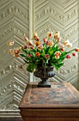 THE LAND GARDENERS, WARDINGTON MANOR, OXFORDSHIRE: TULIPS ARRANGED IN METAL CONTAINER ON WOODEN TABLE. SPRING, ARRANGEMENT, CUTTING