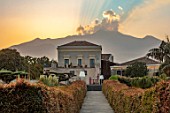 RADICEPURA GARDEN FESTIVAL, SICILY, ITALY: LONG WALKWAY WITH ETNA IN THE BACKGROUND AT SUNSET