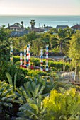 RADICEPURA GARDEN FESTIVAL, SICILY, ITALY: VIEW OVER SHOWGROUND WITH PALMS AND THE BABYLONIAN CRADLE GARDEN TO THE SEA