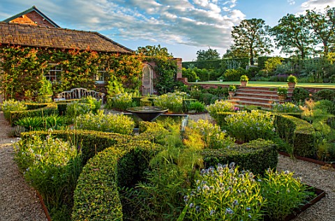 MANOR_FARM_CHESHIRE_VIEW_ONTO_FORMAL_HERB_GARDEN__STEPS_GRAVEL_WATER_FEATURE_BOX_HEDGES_HEDGING_AMSO