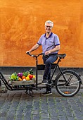 CLAUS DALBY GARDEN, DENMARK: CLAUS DALBY ON A BIKE WITH VEGETABLES