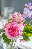 CLAUS DALBY GARDEN, DENMARK: PINK ROSES, FLOWERS IN VASE, DEUTZIA X HYBRIDA STRAWBERRY FIELDS, SHRUBS, BLOOMS, SPRING