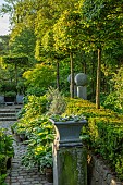 CLAUS DALBY GARDEN, DENMARK: PATIO, GREEN, FOLIAGE, HOSTAS IN CONTAINERS, WATER FEATURE, TERRACE, GARDEN, SUMMER, HEDGES, HEDGING