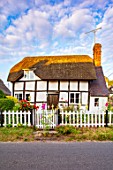 THATCH COTTAGE, WORCESTERSHIRE: THATCHED, FRONT, WHITE, PICKET FENCE, FENCING, BLACK AND WHITE COTTAGE, HOLLYHOCKS, GARDEN, ENGLISH, COTTAGES