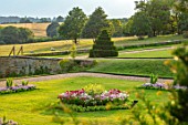 CANONS ASHBY, NORTHAMPTONSHIRE, THE NATIONAL TRUST - LAWNS, SUNDIAL, CEDAR OF LEBANON, BEDDING, BEDS, EVENING, JULY, SLOPES, CLIPPED, TOPIARY, YEW, BORROWED LANDSCAPE