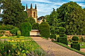 CANONS ASHBY, NORTHAMPTONSHIRE, THE NATIONAL TRUST - LAWN, BEDDING, CHURCH, BORDER, TOPIARY, GRAVEL PATH, JULY, FORMAL, GARDEN