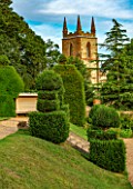 CANONS ASHBY, NORTHAMPTONSHIRE, THE NATIONAL TRUST - LAWN, CHURCH, CLIPPED TOPIARY YEWS, JULY, FORMAL, GARDEN