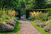 GLYNDEBOURNE, EAST SUSSEX: PATH, BORDERS, URN, STONE CONTAINER, STIPA GIGANTEA