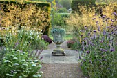 GLYNDEBOURNE, EAST SUSSEX: PATH, BORDERS, URN, STONE CONTAINER PLANTED WITH DICHONDRA SILVER FALLS, STIPA GIGANTEA, VERBENA BONARIENSIS, AMMI VISNAGNA