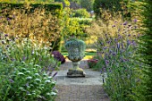 GLYNDEBOURNE, EAST SUSSEX: PATH, BORDERS, URN, STONE CONTAINER PLANTED WITH DICHONDRA SILVER FALLS, STIPA GIGANTEA, VERBENA BONARIENSIS, AMMI VISNAGNA