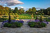 PRIVATE GARDEN, GLOUCESTERSHIRE - DESIGNER ANGEL COLLINS: TERRACE WITH AGAPANTHUS NAVY BLUE, GRASS WALK TO LAKE AND FOUNTAIN