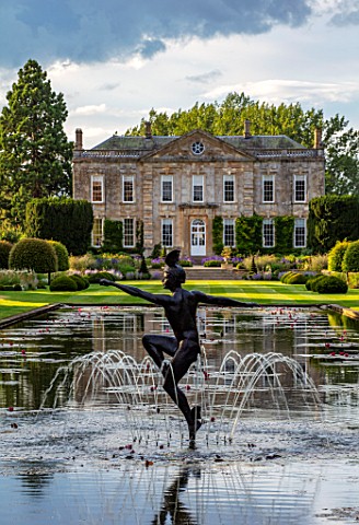 PRIVATE_GARDEN_GLOUCESTERSHIRE__DESIGNER_ANGEL_COLLINS_VIEW_ACROSS_THE_WATERLILIES_IN_LAKE_TO_ABBEY_