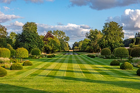 PRIVATE_GARDEN_GLOUCESTERSHIRE__DESIGNER_ANGEL_COLLINS_VIEW_ALONG_GRASS_AVENUE_TO_LAKE_AND_VIEW_OF_C