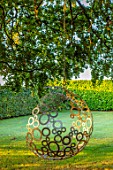 MITTON MANOR, STAFFORDSHIRE: BEECH TREE, BUBBLE SWING SEAT BY MYBURGH DESIGNS, SEPTEMBER, LAWN, TREES, SWINGS, SEATING