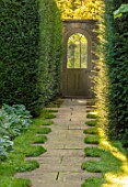 ROCKCLIFFE GARDEN, GLOUCESTERSHIRE: PATH EDGED WITH GRASS, YEW HEDGES, HEDGING, DOOR INTO SWIMMING POOL GARDEN, SEPTEMBER, ENGLISH, COUNTRY, GARDENS