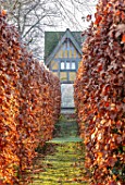 BRYANS GROUND, HEREFORDSHIRE: PATH TO THE DOVECOTE THROUGH BEECH HEDGES, HEDGING, HEDGE, BUILDING, ARTS AND CRAFTS, COUNTRY, GARDEN, WINTER, FROST, FROSTY, JANUARY