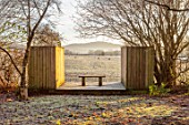 BRYANS GROUND, HEREFORDSHIRE: THE LIGHTBOX, CRICKET WOOD, WINTER, WOODLAND, WOODEN BENCH, SEAT, COUNTRY GARDEN, FROST, FROSTY, BORROWED, LANDSCAPE, VIEW, FOCAL POINT