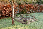 BRYANS GROUND, HEREFORDSHIRE: OLD RUSTY BED SCULPTURE, FROST, FROSTY, WINTER, JANUARY, GARDEN, ORNAMENT, FORMAL, HEDGING, HEDGES, BEECH