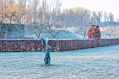 CHIPPENHAM PARK, CAMBRIDGESHIRE: THE WALLED GARDEN, BEECH HEDGES, HARE SCULPTURE, VIEWING MOUND, FROSTED LAWN, WINTER, JANUARY, FROSTY, DAWN, SUNRISE
