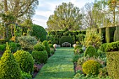 THE LASKETT GARDENS, HEREFORDSHIRE. DESIGNER ROY STRONG - GREEN, FORMAL GARDEN, SPRING, VISTA, LAWN, PATH, CLIPPED TOPIARY, YEW HEDGES, PLEACHED HEDGING
