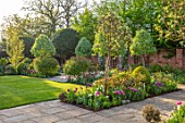 MORTON HALL GARDENS, WORCESTERSHIRE: TULIPS AND FOUNTAIN IN THE SOUTH GARDEN, APRIL, SPRING, PATHS, MORNING LIGHT, LAWN