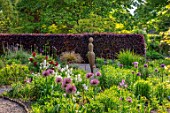 THE PICTON GARDEN AND OLD COURT NURSERIES, WORCESTERSHIRE: MAY, SPRING, BORDER WITH ALLIUM UNIVERSE, PAMONA SCULPTURE BY VICTORIA WESTAWAY
