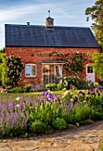 MORTON HALL, WORCESTERSHIRE: WEST GARDEN, EVENING, HOUSE, BORDERS, BEDS, IRISES, PATH, COUNTRY, GARDEN, ENGLISH, CLASSIC
