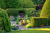 YORK GATE, YORKSHIRE: JUNE, SUMMER, TERRACE, PATIO, CONTAINERS WITH SUCCULENTS, CLIPPED, TOPIARY, HEDGES, HEDGING, YEW, LAWN, AEONIUM ZWARTKOP