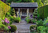 YORK GATE, YORKSHIRE: PORTICO, PATH, HERB GARDEN, CLIPPED, TOPIARY, BOX , YEW, SUMMERHOUSE, HEDGES, HEDGING, SUMMER, JUNE, ALLIUMS, SUMMER, HOUSE