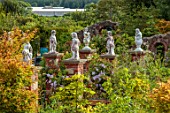 LARCH COTTAGE NURSERIES, CUMBRIA: VIEW OF NURSERY, BRICK PILLARS WITH STATUES, SUMMER, JULY