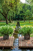 COTON MANOR GARDEN, NORTHAMPTONSHIRE:RILL, WATER, WOODEN BENCH, SLOPE, SLOPING, GRASS, WATER RILL, CANAL