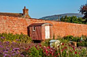 WILDEGOOSE NURSERY, SHROPSHIRE: VIEW TO SHROPSHIRE HILL BEYOND THE WALLED GARDEN, SHED, COUNTRY, GARDENS, AUTUMN
