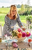 ASHBROOK HOUSE, NORTHAMPTONSHIRE: VANESSA KONIG ARRANGING FLOWERS ON THE DINING TABLE