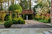 MORTON HALL GARDENS, WORCESTERSHIRE: CLIPPED, BOX TOPIARY, STATUE, GRAVEL, PATH, MAGNOLIA KOBUS OCTOPUS, FORMAL, GARDEN, VIEWPOINT, FOCAL POINT