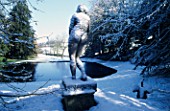 A SNOW COVERED STATUE OF VENUS OVERLOOKS THE OCTAGON POOL IN THE VALE OF VENUS AT ROUSHAM PARK  OXFORDSHIRE