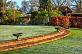 LOWER BOWDEN FARM, BERKSHIRE: SPRING, APRIL, SUNRISE, MORNING, ENGLISH, COUNTRY, GARDEN, LAWN, BRICK STEPS, GREEN METAL URNS, CONTAINERS
