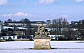 VIEW FROM THE BOWLING GREEN PAST THE STATUE OF A LION AND A HORSE TO THE 3 ARCHED SHAM RUIN. ROUSHAM PARK OXFORDSHIRE