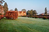 LOWER BOWDEN MANOR, BERKSHIRE: SPRING, APRIL, SUNRISE, MORNING, ENGLISH, COUNTRY, GARDEN - LAWN AND BEECH HEDGES, HEDGING