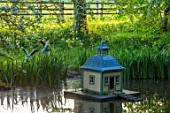 PRIORS MARSTON, WARWICKSHIRE: POOL, POND AND DUCK HOUSE, SPRING, MAY, SCULPTED RABBITS BY WILLIAM YEOWARD, SCULPURE