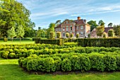 URCHFONT MANOR, WILTSHIRE: EAST FRONT OF HOUSE, CLIPPED TOPIARY BOX SHAPES, FORMAL, CONTEMPORARY, PARTERRE, GREEN, LAWN, DESIGNERS DEL BUONO GAZERWITZ, ELEANOR JONES
