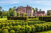 URCHFONT MANOR, WILTSHIRE: EAST FRONT OF HOUSE, CLIPPED TOPIARY BOX SHAPES, FORMAL, CONTEMPORARY, PARTERRE, GREEN, LAWN, DESIGNERS DEL BUONO GAZERWITZ, ELEANOR JONES