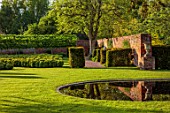 URCHFONT MANOR, WILTSHIRE: YEW HEDGING, HEDGES, FORMAL, CONTEMPORARY, GREEN, LAWN, WATER, POOL, POND, BLACK, DESIGNERS DEL BUONO GAZERWITZ, ELEANOR JONES, REFLECTED, REFLECTIONS