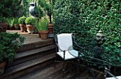 VIEW OF DECKED TERRACE WITH POTS  A LEAD URN & TRELLIS DESIGNER: CHRISTIAN WRIGHT  SAN FRANCISCO