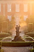 VEN HOUSE, SOMERSET: EARLY MORNING MIST ON FORMAL PARTERRE, TERRACE, WATER FEATURE, FOUNTAIN, TOPIARY, WISTERIA, FOCAL POINT, JUNE, SUMMER