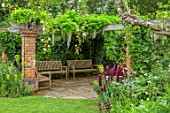 STOCKCROSS HOUSE, BERKSHIRE, PLANTING DESIGN BY ISTVAN DUDAS: WOODEN PERGOLA WITH WOODEN BENCHES, WHITE WISTERIA, LUPINS
